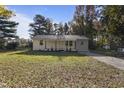 Newly renovated ranch home with a front yard and driveway at 1924 Carr Creek Rd, Sanford, NC 27330