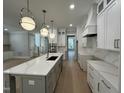 Modern kitchen with large island, white cabinets, and quartz countertops at 314 Hinton St, Apex, NC 27502
