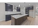 Modern kitchen with dark cabinetry, white countertops, and island at 75 Arbor Dr, Youngsville, NC 27596