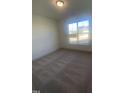 Spacious bedroom with neutral carpeting and large window at 110 Sawtooth Oak Ln, Youngsville, NC 27596