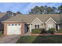 Two-story home with brick and stone accents, attached garage, and landscaping at 11331 Involute Pl # 100, Raleigh, NC 27617