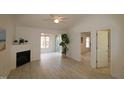 Bright living room with fireplace, hardwood floors, and sliding glass doors at 11331 Involute Pl # 100, Raleigh, NC 27617