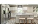 Modern kitchen with white cabinets, stainless steel appliances, and an island at 600 Mathiola Dr, Wendell, NC 27591