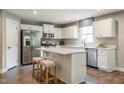 Modern kitchen with white cabinets, stainless steel appliances, and an island at 600 Mathiola Dr, Wendell, NC 27591