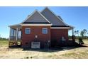 The backside of a brick home with a screened-in porch and a well-maintained lawn at 7575 Sweetwater Dr, Nashville, NC 27856