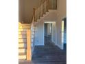 Bright staircase with wooden stairs and white railing leads to the upper level of the home at 7575 Sweetwater Dr, Nashville, NC 27856