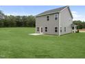 Two story house with gray siding, large backyard, and patio at 8816 Melvin St # 15, Willow Springs, NC 27592