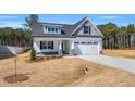 Charming two-story home with a front-facing two car garage and professionally landscaped yard at 91 Laramie Ln, Selma, NC 27576