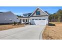 Charming two-story home with a front-facing two car garage and professionally landscaped yard at 91 Laramie Ln, Selma, NC 27576
