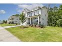 Charming two-story house with a well-maintained lawn and landscaping, and a mix of siding and stone accents at 115 Arundel Dr, Archer Lodge, NC 27527
