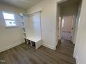 Well-lit mudroom with custom built-in storage and durable wood-look flooring at 115 Arundel Dr, Archer Lodge, NC 27527