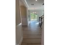 Inviting entryway with hardwood floors leading to a bright and open living area with a modern chandelier at 116 Arundel Dr, Archer Lodge, NC 27527