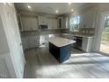 Bright kitchen features sleek countertops, stainless steel appliances, and a center island at 116 Arundel Dr, Archer Lodge, NC 27527