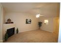 Open living room with fireplace and neutral decor at 2410 Huntscroft Ln # 203, Raleigh, NC 27617