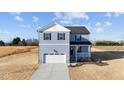 Charming two-story home with a front-facing garage and a welcoming front porch at 55 Diamond Creek Dr, Zebulon, NC 27597