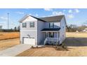 Charming two-story home with a front-facing garage and a welcoming front porch at 55 Diamond Creek Dr, Zebulon, NC 27597
