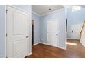 Welcoming foyer with hardwood floors, white trim, and convenient access to other rooms at 809 Davidson Point Rd, Cary, NC 27513