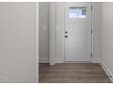 Bright entryway features a white front door with glass pane and wood-look flooring at 41 Red River Dr, Selma, NC 27576