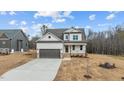 Two-story house with neutral siding, brown garage door, and landscaping at 55 Basil Ct, Franklinton, NC 27525