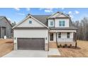 Two-story house with neutral siding, brown garage door, and landscaping at 55 Basil Ct, Franklinton, NC 27525