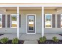 The front entrance features a glass door and gray siding at 927 Micro W Rd, Selma, NC 27576