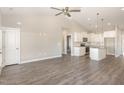 Open living room with kitchen island and vaulted ceilings at 927 Micro W Rd, Selma, NC 27576
