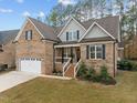 Charming brick two-story home with a well-manicured lawn and attached two car garage at 184 Dereham Ln, Garner, NC 27529