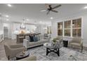 Open concept living space with modern gray decor, flowing into a bright eat-in kitchen at 184 Dereham Ln, Garner, NC 27529