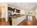 Open kitchen featuring granite countertops and dark wood cabinets at 219 Rosedale Creek Dr, Durham, NC 27703