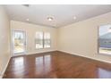 Inviting living room with natural light and hardwood floors offers a warm and spacious area at 219 Rosedale Creek Dr, Durham, NC 27703