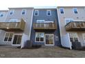 Townhome backyards with patios, balconies, and privacy fences under a clear sky at 2325 Bay Minette Sta # 548, Apex, NC 27502