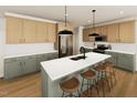 Modern kitchen with an island, stainless steel appliances, and wood-style cabinets at 252 Beacon Dr, Pittsboro, NC 27312