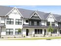 Charming townhome featuring a stone foundation and an attractive front lawn at 324 Church St, Morrisville, NC 27560
