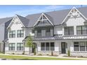 Charming townhome featuring a stone foundation and an attractive front lawn at 324 Church St, Morrisville, NC 27560