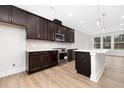 Stylish kitchen featuring stainless steel appliances, an island, and modern cabinets at 324 Church St, Morrisville, NC 27560