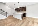 Modern kitchen with stainless appliances, central island, stylish cabinets, and hardwood flooring at 324 Church St, Morrisville, NC 27560