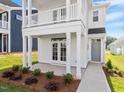 Close up view of a charming two-story home with a double porch, showcasing its inviting entrance at 716 Georgias Landing Pkwy # 12, Raleigh, NC 27603
