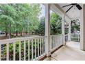 Relaxing back porch with white railings, offering serene views of the surrounding wooded landscape at 1620 Dunn Rd, Raleigh, NC 27614