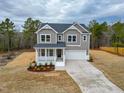 Charming two-story home with a welcoming front porch and attached two-car garage at 320 Duncan Creek Rd # 161, Lillington, NC 27546