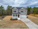 Charming two-story home with a welcoming front porch and attached two-car garage at 320 Duncan Creek Rd # 161, Lillington, NC 27546