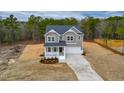 Charming two-story home with a welcoming front porch and attached two-car garage at 320 Duncan Creek Rd # 161, Lillington, NC 27546