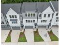 Overhead shot of new townhomes with gray roofs, drive-under garages, and modern exteriors at 4505 Mint Leaf Ln, Raleigh, NC 27612
