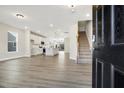 Open-concept living space with hardwood floors, kitchen, and staircase at 472 Traditions Grande Blvd # 34, Wake Forest, NC 27587