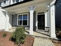 Charming home featuring stone accents, gray siding, white pillars, and a covered front porch at 476 Traditions Grande Blvd # 33, Wake Forest, NC 27587