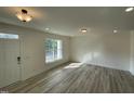 Bright, airy living room features hardwood floors, recessed lighting, and a large window at 476 Traditions Grande Blvd # 33, Wake Forest, NC 27587