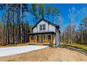 Beautiful two-story home with wood porch in a serene wooded setting at 169 Running Deer Dr, Louisburg, NC 27549