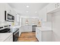 Modern, white kitchen with stainless steel appliances and ample counter space at 169 Running Deer Dr, Louisburg, NC 27549