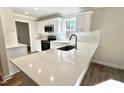 White kitchen with quartz countertops, stainless steel appliances, and white subway tile backsplash at 169 Running Deer Dr, Louisburg, NC 27549