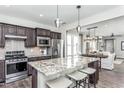 Open concept kitchen with large island, stainless steel appliances, and breakfast bar at 2513 Shorebird Dr, Fuquay Varina, NC 27526