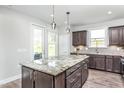 Kitchen island with granite countertop and stainless steel appliances at 2513 Shorebird Dr, Fuquay Varina, NC 27526